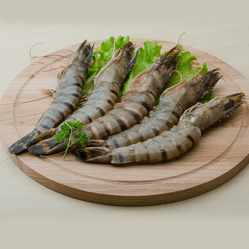 Jumbo tiger prawns on a wooden board